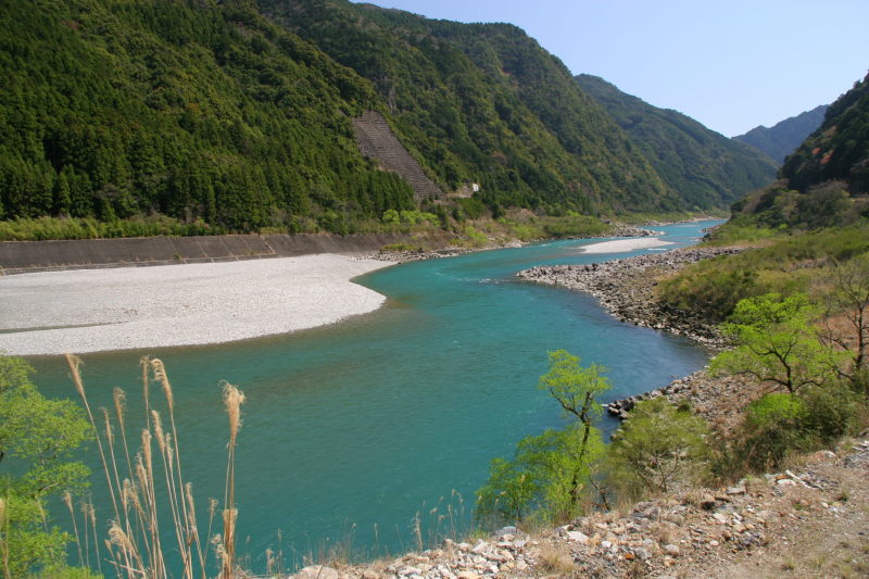The Kumano River and its emerald waters seem to glow in the mid-day sun.