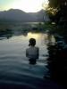 A bather enjoys the evening sunset and the view of Lake Kussharo.